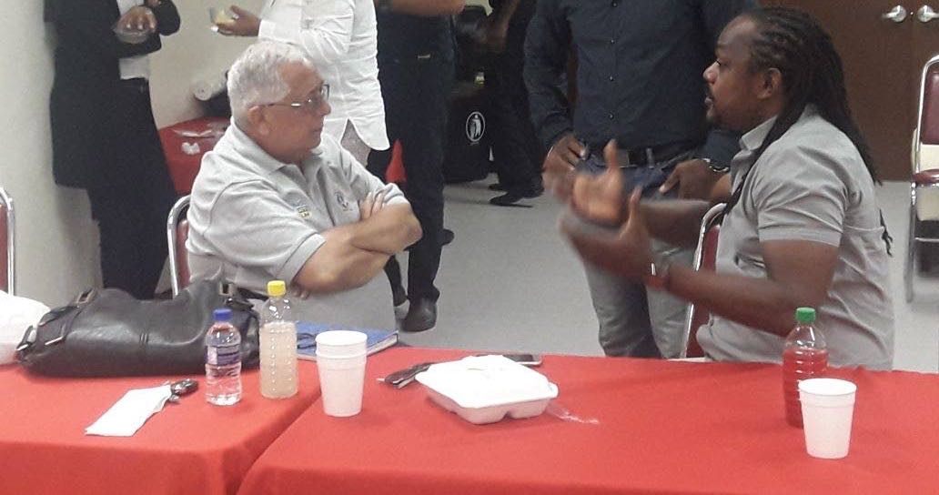 Richard Fakoory, left, listens to Central FC owner Brent Sancho during last week’s UEFA/T&T Pro League seminar.