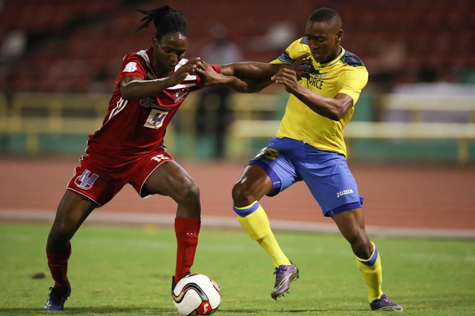 Central FC’s Kaydion Gabriel, left, and Defence Force FC winger Reon Moore vie for the ball during the First Citizens Cup final at the Hasely Crawford Stadium on Jul. 20, 2018. (Courtesy First Citizens/CAI/Allan V. Crane)