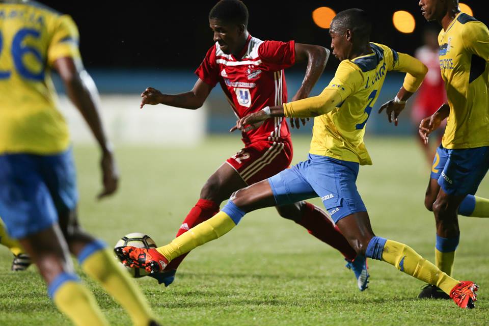 Photo: Defence Force defender Jamali Garcia (#3) tries to stop a run by Central FC’s Jameel Neptune during their group stage clash of the First Citizens Cup at Ato Boldon Stadium on Jun. 22, 2018. (Courtesy First Citizens/CAI/Allan V. Crane)