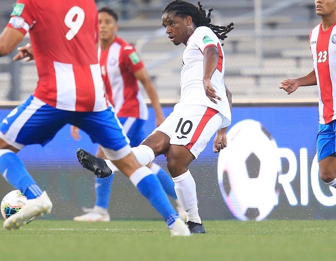 Photo: Trinidad and Tobago midfielder Duane Muckette (centre) looks for a teammate during World Cup qualifying action against Puerto Rico at the Estadio Centroamericano in Mayaguez on 28 March 2021. (via TTFA Media)