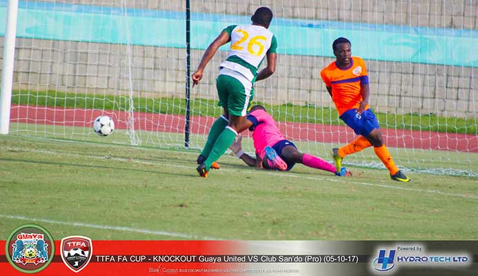 Guaya United forward Kevin Jagdeosingh (#26) watches the ball past Club Sando goalkeeper Kelvin Henry during their FA Trophy 2017 Round-of-32 clash at the Mannie Ramjohn Stadium on Oct. 5, 2017. Guaya won the game 6-5 on penalties after a 1-1 draw. (Photo courtesy Guaya United / Hydro Tech Ltd)