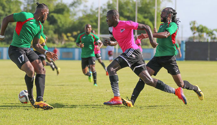 San Juan Jabloteh defender Josiah Trimmingham (L) and midfielder Keyon Edwards (R) tries to stop Central FC attacker Rundell Winchester during the 2016/17 Digicel Pro League.