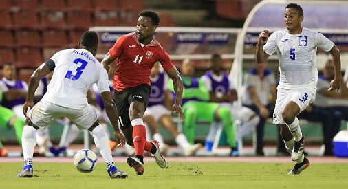 T&Ts Levi Garcia (11) tries to get past Honduras’ Maynor Figueroa during their CONCACAF Nations League matchup at the Hasely Crawford Stadium, Mucurapo, on Thursday night. Honduras won 2-0. - CA-images