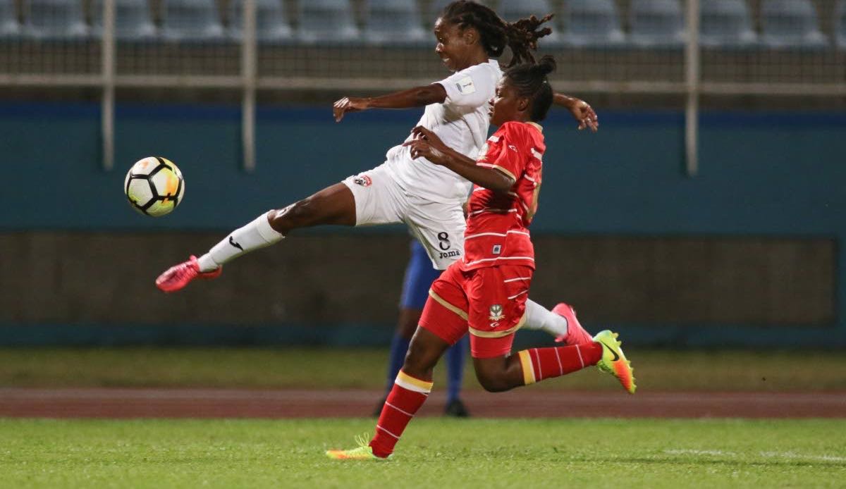 T&T’s Patrice Superville goes airborne to make a cross against St Kitts and Nevis in a CONCACAF Women’s Championship Qualification match at the Ato Boldon Stadium, Couva, yesterday.