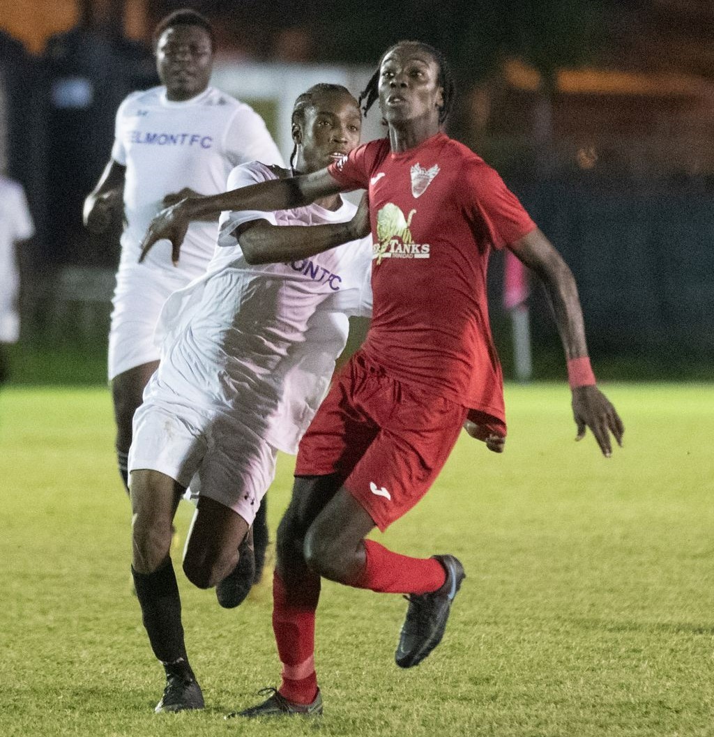 Phoenix FC Jariel Arthur, right, and Belmont’s Christian Morris battle for the ball during the Zonal Champion of Champions at Phase 2 Recreation Grounds in La Horquetta, on February 10. The match ended in a 1-1 draw. On Friday, Belmont faced off against Pitchmen FC and emerged with a 4-3 victory. ...Daniel Prentice