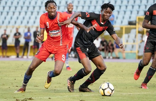 Caledonia’s Tev Lawrence (L) vies with a Phoenix player for he ball during match day 3 of the TT Pro Legue First Citizens Cup 2019 between Morvant Caledonia and Phoenix FC, at the Hasely Crawford Stadium, Port of Spainnon Sunday. - Daniel Prentice/CA-images
