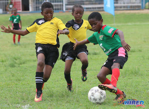 Photo: San Juan Jabloteh’s Raheem Mohan (right) tries to elude two Cunupia Extreme players during RBNYL Under-11 action at Constantine Park in Macoya on 10 June 2017. Jabloteh won 2-0. ...(Courtesy Sean Morrison/Wired868)