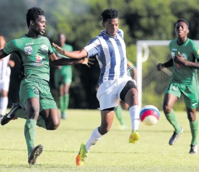 St Mary’s Trey La Motte controls the ball ahead of Signal Hill’s Jelani James (#8) during the Intercol National Quarterfinal yesterday at Plymouth Recreational Grounds, Tobago.
