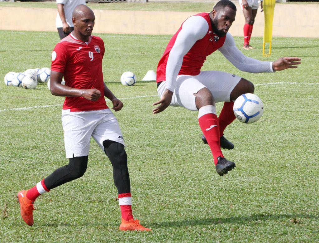 US-based T&T defender Josiah Trimmingham, right, attempts to control the ball while being closely watched by striker Brent Sam, as preparation for the T&T team heightens ahead of the World Cup Qualifiers in March, continued on Tuesday at the Police Grounds in St James. Trimmingham plays for USL League One club Madison FC. - ANTHONY HARRIS
