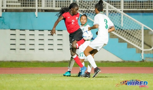 Photo: Trinidad and Tobago defender J’elecia Alexander (left) tries to escape from two Suriname opponents during CFU Challenge Series action at Couva on 27 October 2019. (Copyright Daniel Prentice/CA-Images/Wired868)