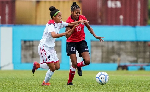 T&T’s Arjoon Summer, right, is harassed by Dominican Republic’s Nicole De Jesus during their Concacaf Women’s Olympic Zone Qualifier at the Ato Boldon Stadium in Couva yesterday. The match ended 0-0. 
