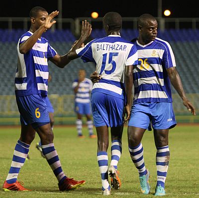 T&T Defence Force midfielder Jerwyn Balthazar, centre, celebrates with teammates during a Pro League clash against San Juan Jabloteh earlier this season. Defence Force won the match 2-0, before withdrawing from the competition. The Army will return to the Pro League today in a rescheduled clash with Central FC, at the Ato Boldon Stadium, Couva, from 6 pm. Photo: Anthony Harris