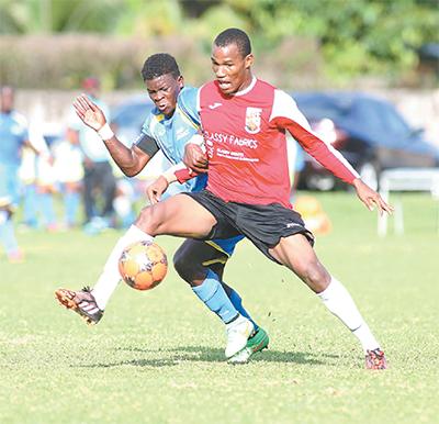 St Anthony’s Shakeem Patrick, right, vies for the ball against Shiva Boys’ Isaiah Garcia during the BGTT/First Citizens Secondary Schools Football Premier Division League at the St Anthony’s school ground in Westmoorings, yesterday. The match ended in a 1-1 draw. PHOTO: MICHEAL BRUCE