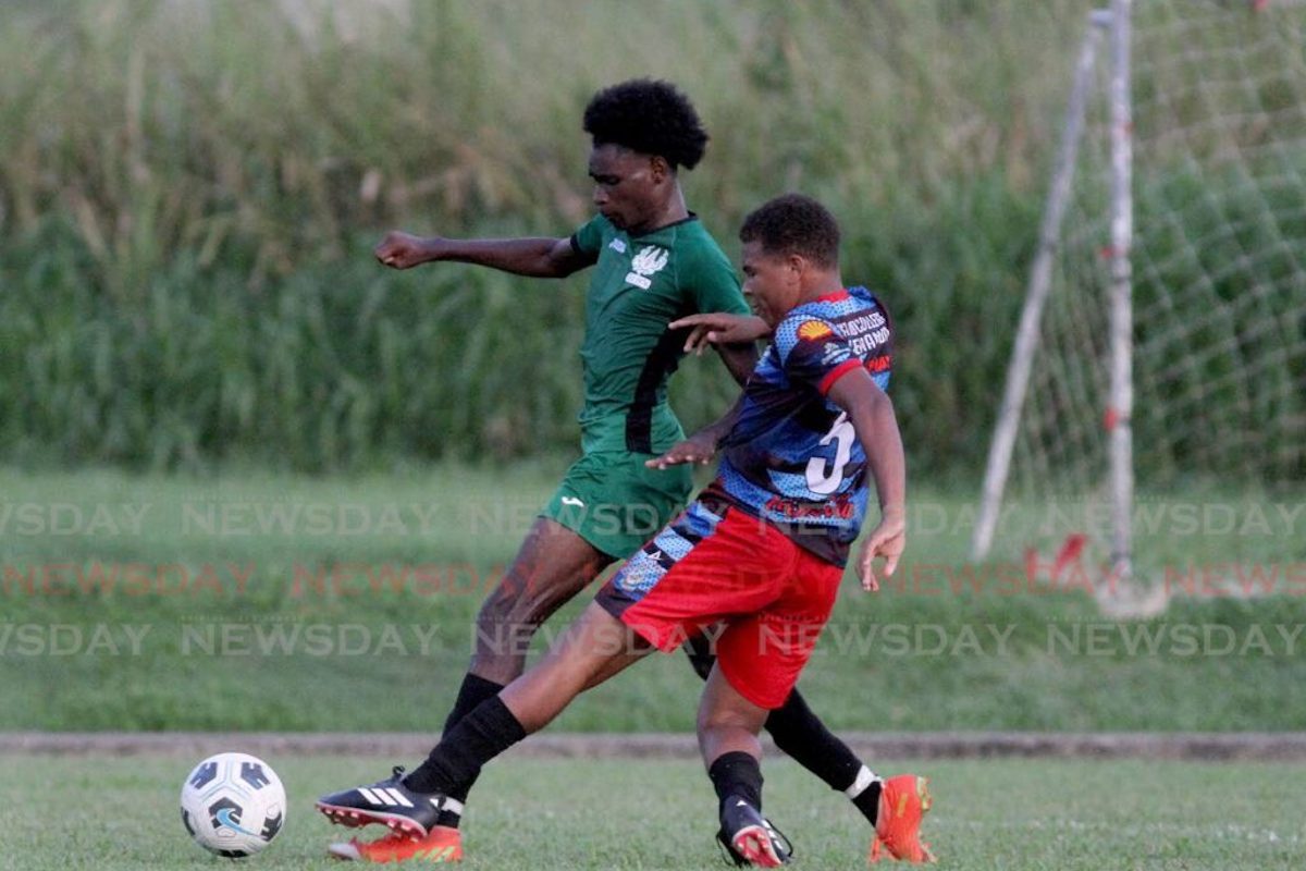 ASJA Boys’ College’s Torres Ramjattan, right, tackles St Madeleine Secondary’s Tyrell Dyeth during a Secondary Schools Football League Championship match at the Manny Ramjohn Stadium, Marabella, Friday. Ste Madeleine won 3-2. - PHOTO: AYANNA KINSALE