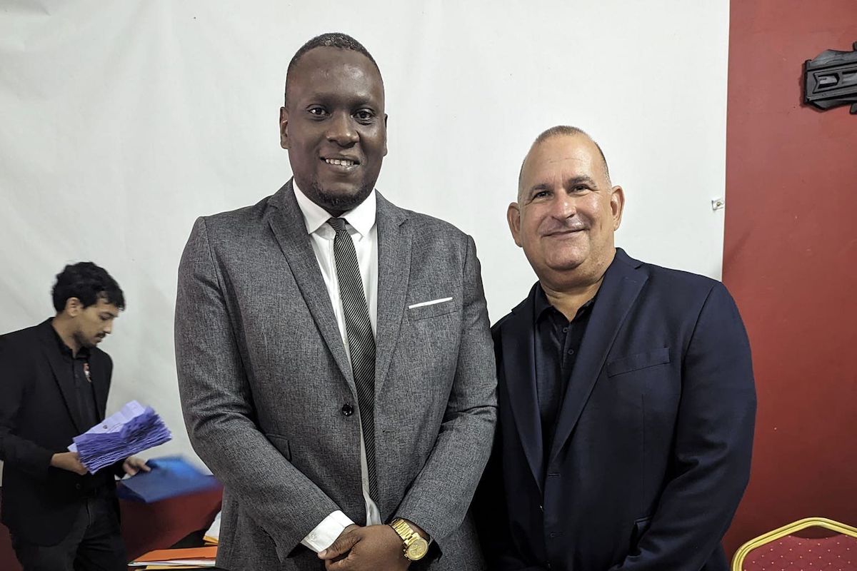New TTFA President Kieron Edwards (left) with outgoing Chairman of the Normalization Committee, Robert Hadad (right).