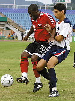 Russell Latapy of T&T collects cleanly and screens off Dominican Republic’s defender Francisco Torres during the first half of play in the warm-up match yesterday at Hasely Crawford Stadium in Mucurapo. T&T won 9-0. ...Photo: Anthony Harris (T&T Guardian)