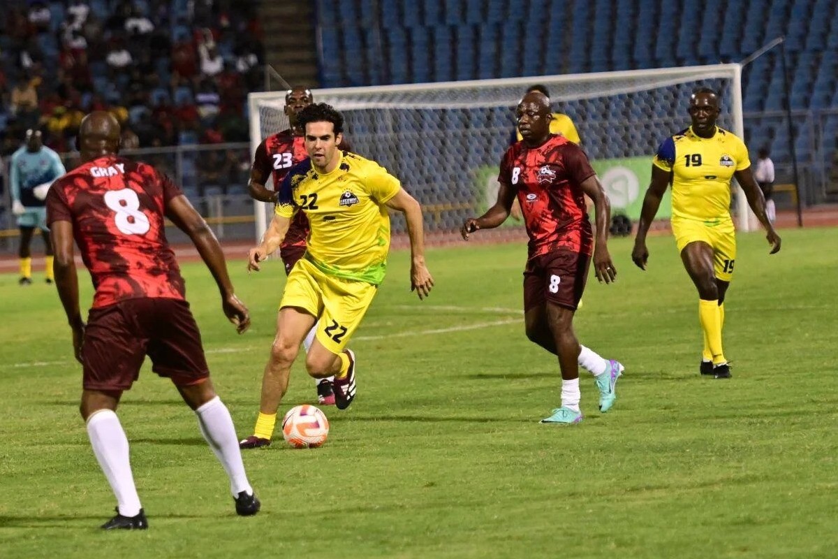 Legends’ Kaka, centre, goes on a mazy run as Trinidad and Tobago All-Stars’ Cyd Gray, left, looks to defend during the exhibition charity event on Friday, May 10th 2024, at the Hasely Crawford Stadium, Mucurapo. Kaka scored a hat-trick as the game ended 5-5.