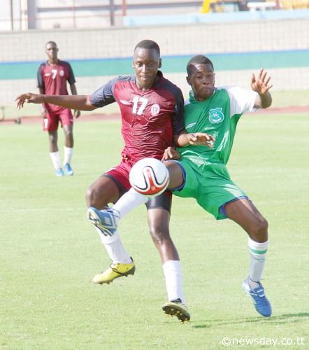 PLEASANTVILLE SECONDARY striker Arnim Perreira is under a determined challenge from Princes Town defender Marvin Tracey (right), during their BGTT/First Citizens Secondary Schools match in the South zone which ended 0-0 on Wednesday. (Photo - T&T Newsday).