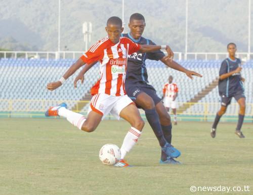 ST ANTHONY'S Kiel Pierre, left, unleashes a shot while closely marked by Queen's RoyalCollege's Adrian Constantine in their Secondary Schools Football League opener at theHasely Crawford Stadium, Mucurapo, yesterday. St Anthony's prevailed 3-1. ...Author: ROGER JACOB