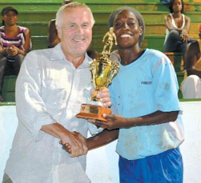 Defender Rhea Belgrave, right, receives the Player of the Final trophy from Director of National Women’s Football and sponsor of the tournament, Even Pellerud, at the closing ceremony of the Women’s League Football (Wolf) Big-Four. 