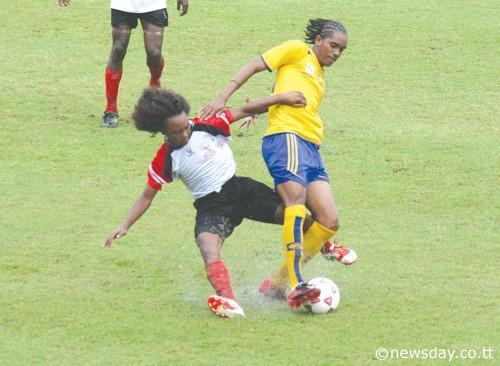 DWIGHT POPE, (right) of Shiva Boys Hindu School is tackled by Aaron Julien of MorugaSecondary School during action in the Coca Cola Intercol Football play-off yesterday at the Manny Ramjohn Stadium. Shiva Boys won the game 5-0 to advance. ...Author: LISA-LEWIS SCOTLAND 