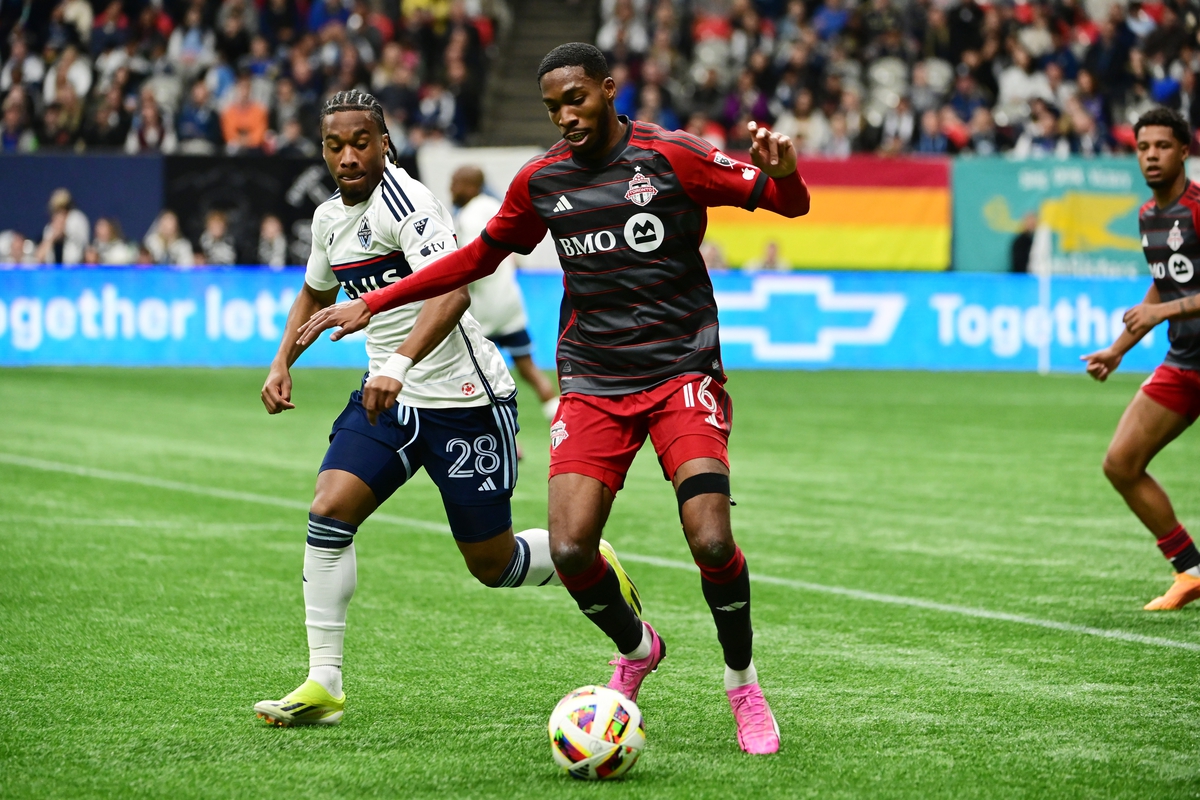 Apr 6, 2024; Vancouver, British Columbia, CAN; Toronto FC forward Tyrese Spicer (16) and Vancouver Whitecaps FC forward Levonte Johnson (28) battle for the ball in the second half at BC Place. Mandatory Credit: Simon Fearn-USA TODAY Sports