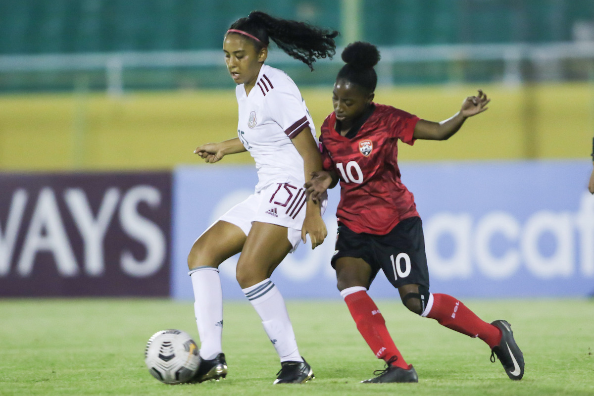 Trinidad and Tobago's Jeniecia Benjamin (#10) challenges for the ball during a Concacaf Women's U-17 Championship match against Mexico on Wednesday, April 27th at Estadio Olímpico Félix Sánchez, Santo Domingo, Dominican Republic.