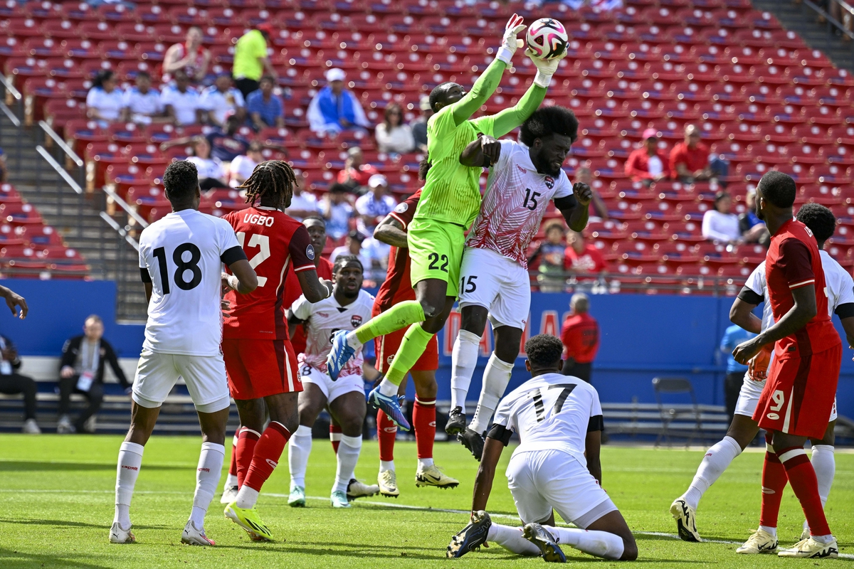 Mar 23, 2024; Frisco, Texas, USA; Trinidad and Tobago goalkeeper Denzil Smith (22) and midfielder Neveal Hackshaw (15) leap for the ball while Canada forward Ike Ugbo (12) and forward Cyle Larin (9) look on during the first half at Toyota Stadium. Mandatory Credit: Jerome Miron-USA TODAY Sports
