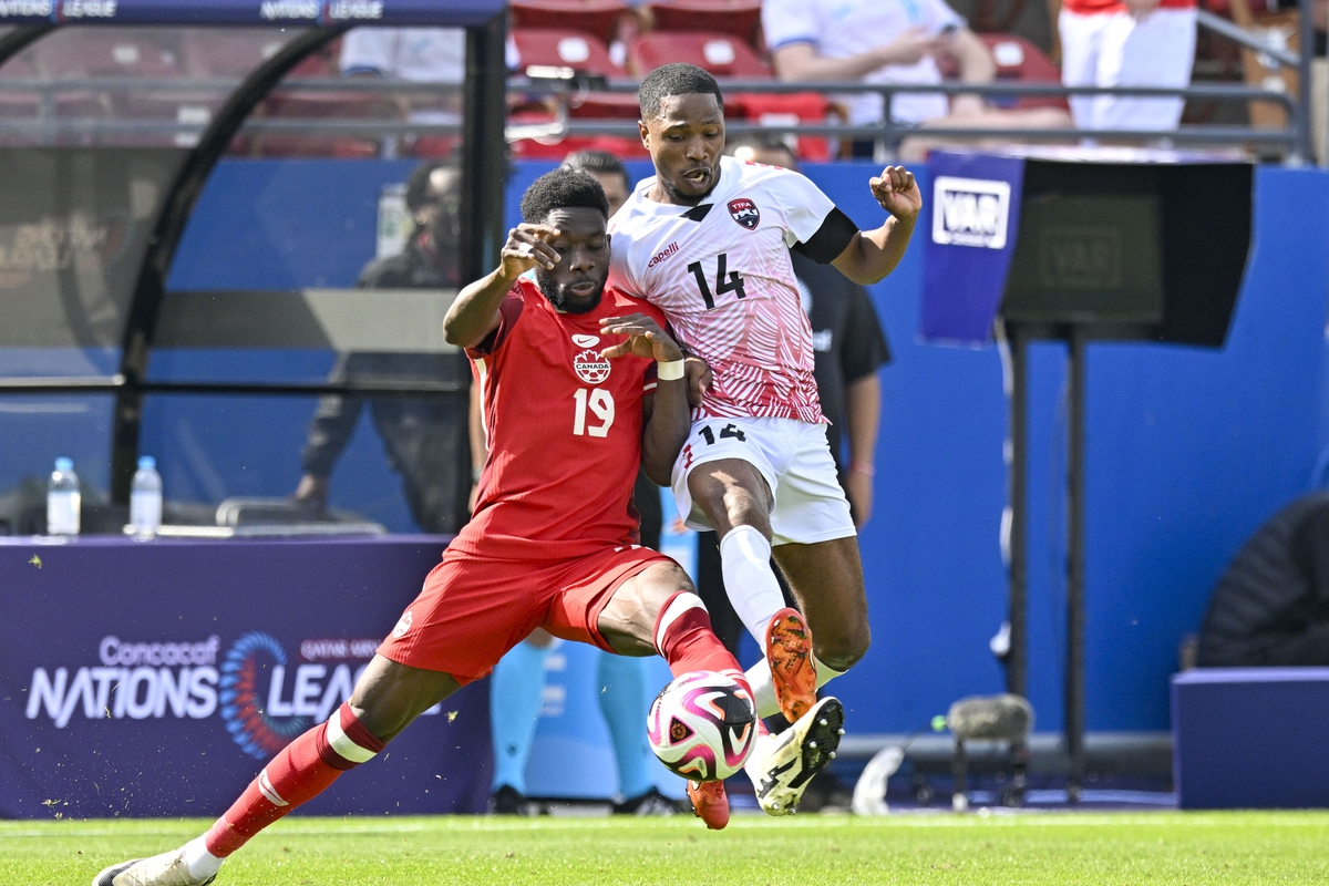 Mar 23, 2024; Frisco, Texas, USA; Canada midfielder Alphonso Davies (19) and Trinidad and Tobago defender Shannon Gomez (14) battle for control of the ball during the second half at Toyota Stadium. Mandatory Credit: Jerome Miron-USA TODAY Sports