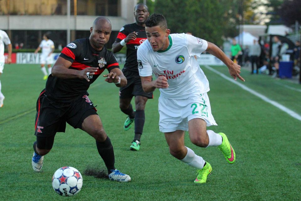 San Antonio Scorpions defender Julius James #3 and New York Cosmos midfielder Leo Fernandes #22 fight for the ball during the first half of a game at Hofstra University's James M. Shuart Stadium on Saturday, May 23, 2015. (Credit: Brad Penner)