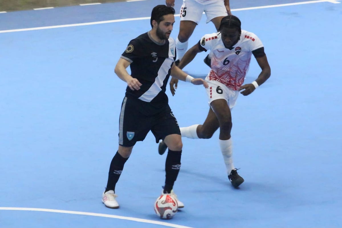 Trinidad and Tobago's Sedate McLean keeps pace with a Guatemalan player during a 2024 Concacaf Futsal Championship match at Polideportivo Alexis Arguello, Managua, Nicaragua on Sunday, April 14th 2024.