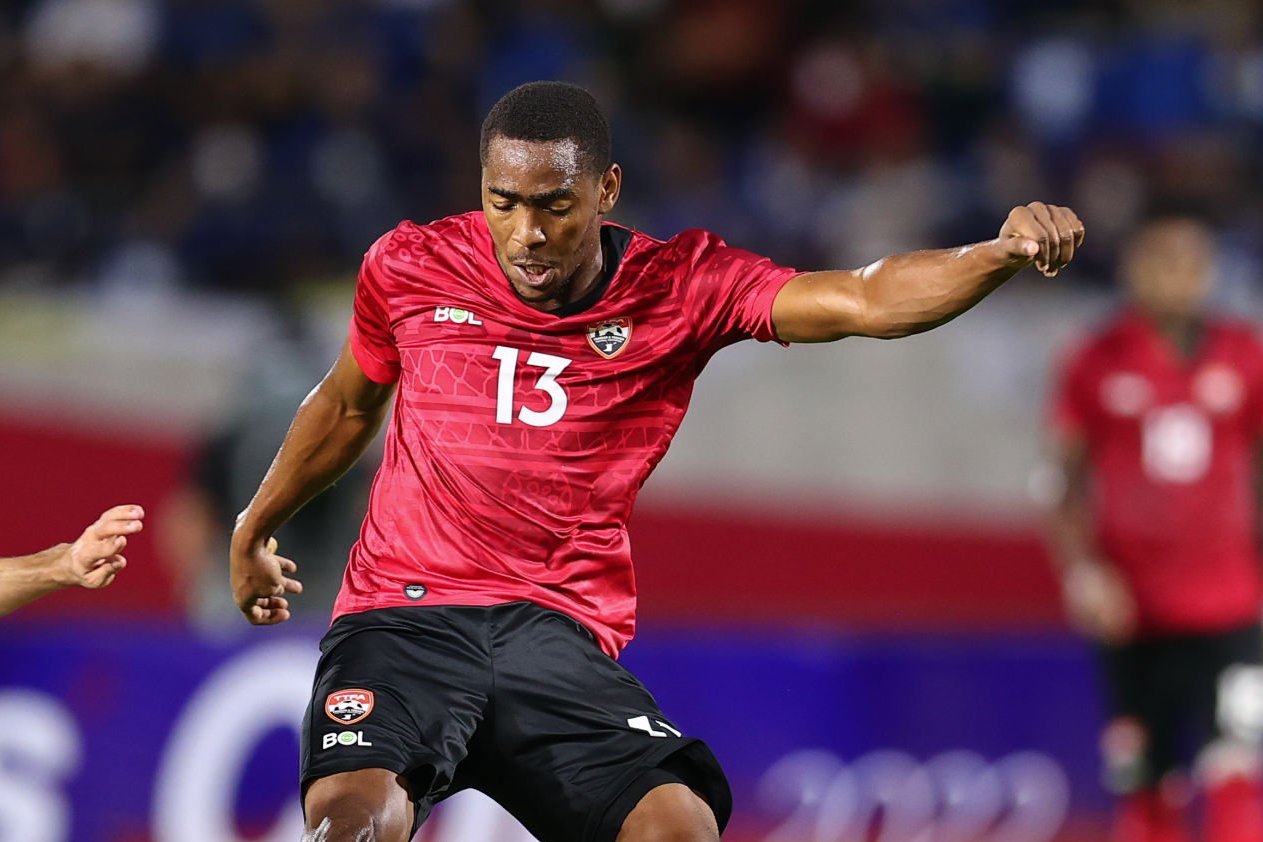 Reon Moore of Trinidad and Tobago (R) kicks the ball under pressure during the international friendly match between Trinidad and Tobago and Tajikistan at 700th Anniversary Stadium on September 22, 2022 in Chiang Mai, Thailand. (Photo by Pakawich Damrongkiattisak/Getty Images)
