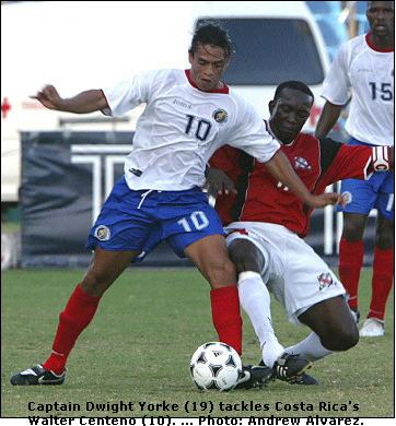 Costa Rica's Walter Centeno up against Dwight Yorke