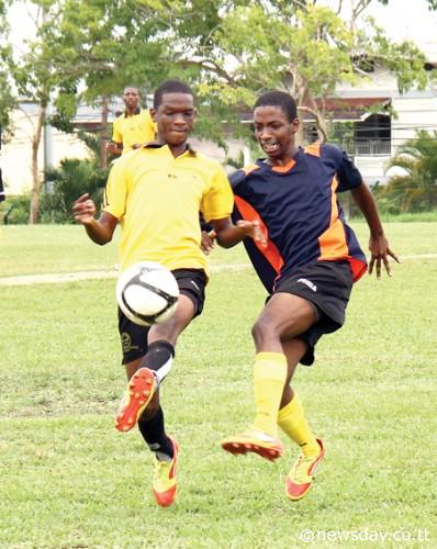 Andell Jones of Toco Secondary, left, controls the ball under pressure from El Dorado West's Shakeem Charles in their Secondary Schools Football League match at El Dorado Grounds, yesterday. ...Author: SUREASH CHOLAI
