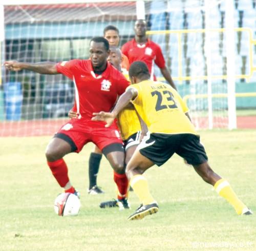 ST ANN'S Rangers forward Errol Mc Farlane Jr, left, attempts to dribble past T&TEC'sKevin Modeste, right, in their First Citizens Cup match at the Hasely Crawford Stadium,Mucurapo on Friday. ...Author: SUREASH CHOLAI