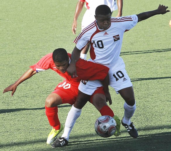 Bermuda’s Frank Garcia, left, battles for the ball with T&T midfielder Jomal Williams in their Caribbean Football Union Group E qualifier at the Marvin Lee Stadium, Macoya, yesterday. Williams scored a pair in T&T’s 2-1 win. Photo: Anthony Harris.
