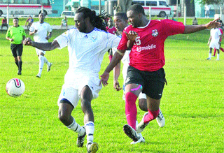 SUPER LEAGUE ACTION: Joe Public striker Brent Antoine, right, battles with WASA defender Akil Harley, left, and midfielder Jesse Reyes in a bmobile Super League match at St Joseph last month. The game ended 1-1. Antoine scored the opening goal on Wednesday when Joe Public beat St Francois Nationals 3-1 at Marvin Lee Stadium.