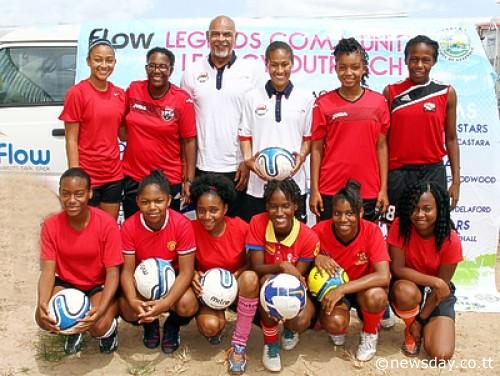 England's Rachel Yankey, back centre, poses with George Berry of the Professional Footballers Association and members of the St Augustine Secondary School. Photo: Sureash Cholai