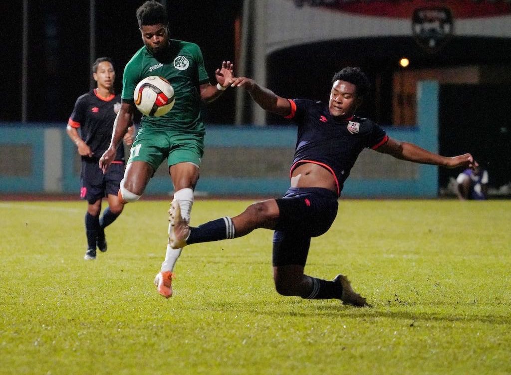 AC Port-of-Spain defender Seon Thomas, right, puts in a late tackle against W Connection defender Adan Noel during their TT Pro League match at the Ato Boldon Stadium, Couva, on Friday night. W Connection won 2-0. ...Daniel Prentice/CA-images