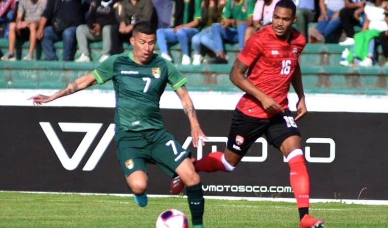 T&T defender Alvin Jones, right, looks on as Bolivia's Juan Carlos Arce attempts to cross the ball during their friendly match in Sucre, Bolivia on Friday. Bolivia won the match 5-0.  Courtesy TTFA Media