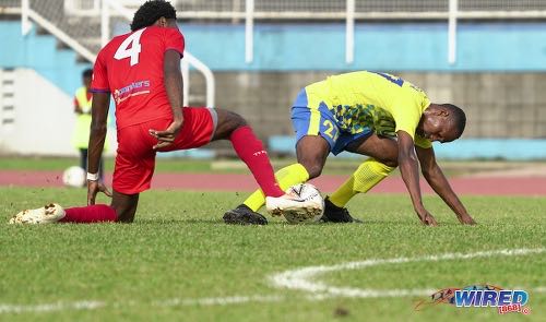 Photo: Defence Force midfielder Aaron Lester (right) tries to keep possession under pressure from Morvant Caledonia defender Otev Lawrence during Pro League action at the Hasely Crawford Stadium on 25 January 2020. (Copyright Daniel Prentice/CA-Images/Wired868)