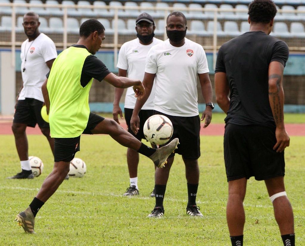 National senior men’s football assistant coach Hutson Charles just behind head coach Angus Eve, second from right, during a training session in June. Charles was dropped by Eve from the national staff to be replaced by a data analyst.  Anthony Harris