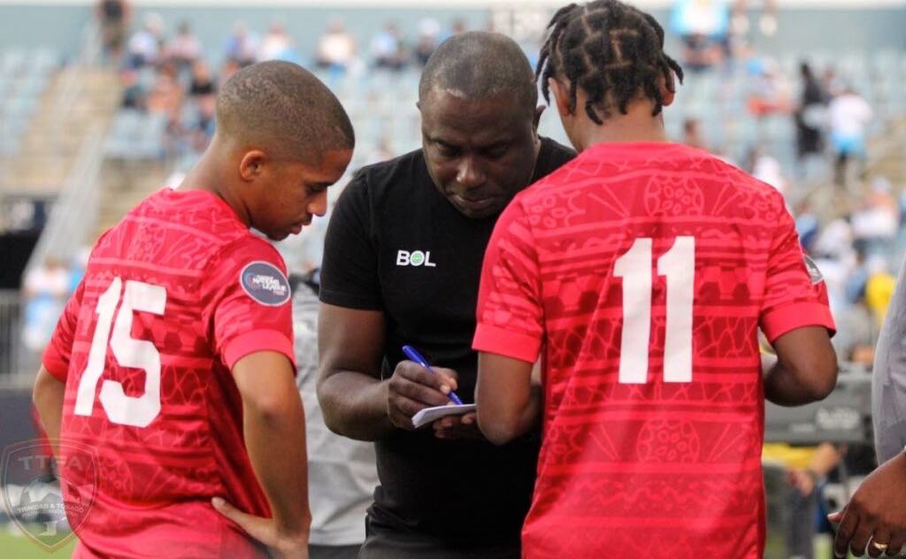 T&T head coach Angus Eve, centre, talks to TT players Kaile Auvray, left, and Real Gill before sending them on as substitutes in a friendly vs Guatemala at Subaru Park, Philadelphia recently. - TTFA Media