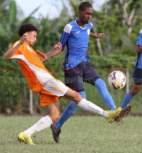 Valencia High School's Mikhail Mollino, (L) and Keyel James of Arima North Secondary, battle for the ball during the SSFL East Zone final ,at Valencia High on Tuesday afternoon. Arima won 3-2. - ANGELO_MARCELLE