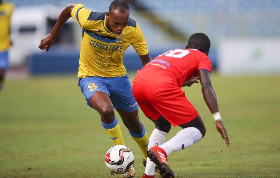 Photo: Defence Force FC forward Brent Sam attempts to drive past Morvant Caledonia United’s Travell Edwards during their First Citizens Cup 2018 semi-final clash at the Hasely Crawford Stadium on Jul. 13, 2018. (Courtesy First Citizens/CAI/Allan V. Crane)