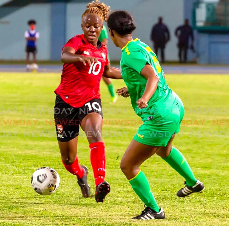 T&T's Asha James (10) controls the ball against a Guyana senior women's player during the Concacaf World Cup qualifier, at the Dwight Yorke Stadium, Bacolet, on Tuesday. Photo by David Reid