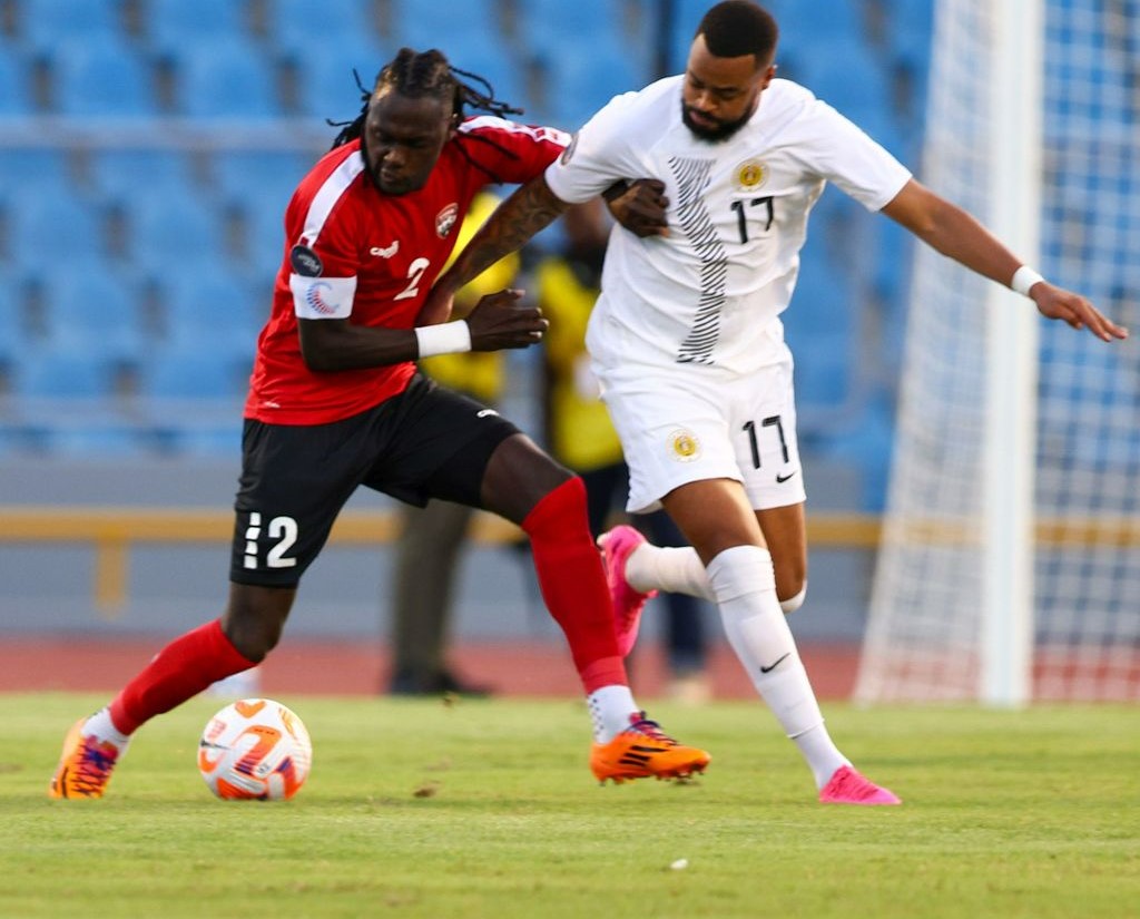 T&T captain Aubrey David, left, battles with Curacao's Brandley Kuwas during the Concacaf Nations League 'A' match at the Hasely Crawford Stadium, Mucurapo on Thursday. T&T won 1-0. ...DANIEL PRENTICE