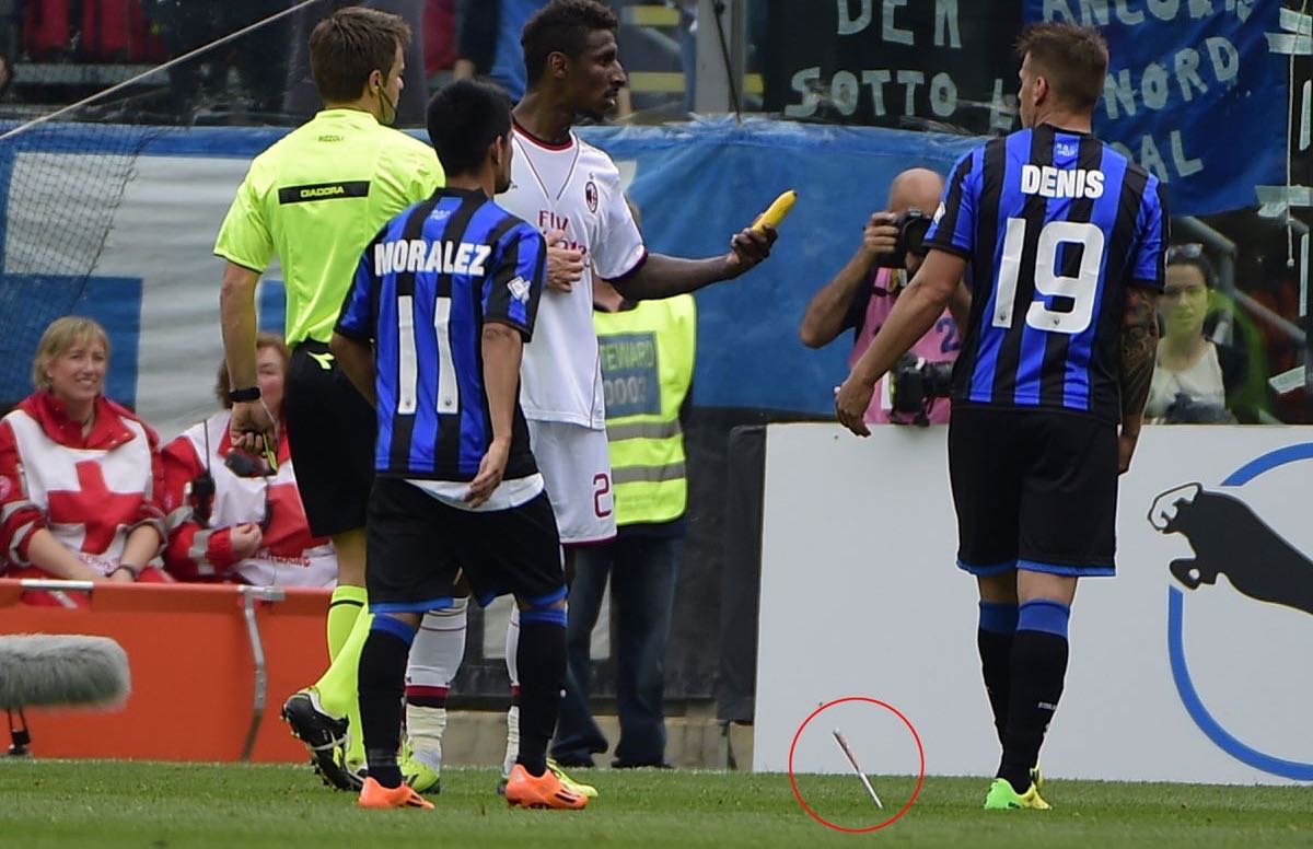 AC Milan's Kevin Constant notices a banana thrown at him but doesn't see the knife-like object that was also tossed from the stands. (AFP PHOTO / OLIVIER MORINOLIVIER)