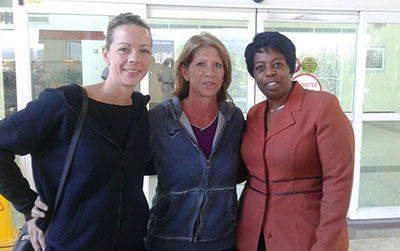 Newly appointed national women's football coach Carolina Morrace, centre, at the Piarco International Airport on her arrival to T&T, yesterday afternoon. With her is assistant coach Nicola Williams, left, and Joanne Salazar, the third vice-president in the T&T Football Association (TTFA).