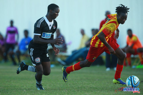 Photo: Point Fortin Civic midfielder Akeem Redhead (right) takes Central FC wing back Kaydion Gabriel for a run during the 2014/15 season. (Courtesy Allan V Crane/Wired868)
